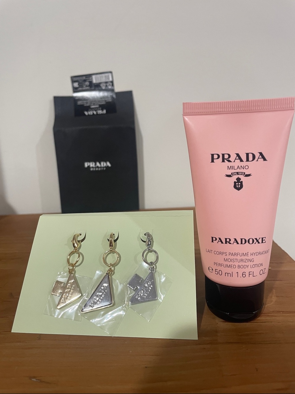 🎉 Prada Paradoxe Lotion & Triangle Logo Charms